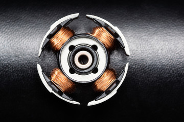 Dc motor rotor from the mini motor on black texture background