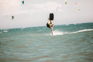 Kitesurfing. Man rides on kite on waves