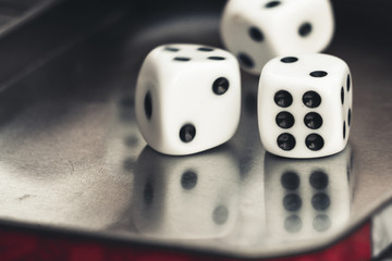 Dice reflecting in a metal surface