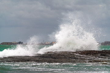 Big waves breaking coastal rocks