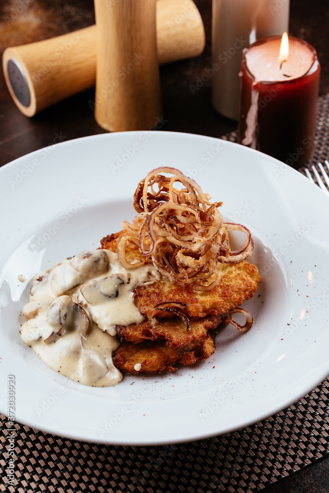 Wall mural potato pancakes with mushroom sauce and onions