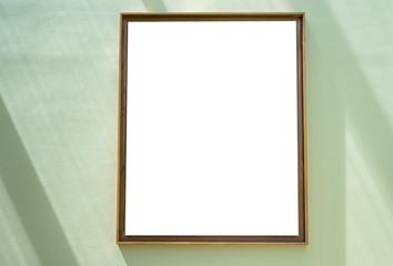 Blank frame hanging on the green wall.