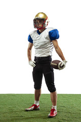 Confident posing. American football player isolated on white studio background with copyspace. Professional sportsman during game playing in action and motion. Concept of sport, movement, achievements