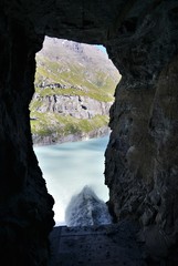 strong water jet from cave in the alps in switzerland
