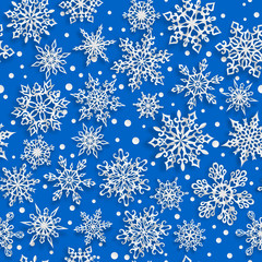 Christmas seamless pattern of paper snowflakes with soft shadows on blue background