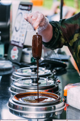 Glazed ice cream on a stick dipped in hot chocolate