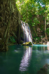 Clear stream that flows through the rocks. Falling into the Emerald Pool, Erawan Kanchanaburi, Thailand.