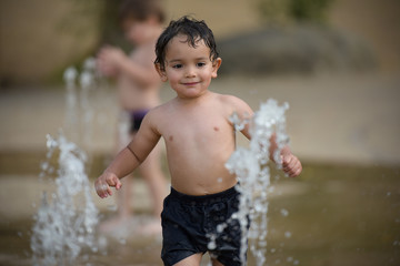 young boy playing at the paddling pool