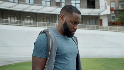 Sportsman getting message on smartwatch. Runner using smart watch at racetrack