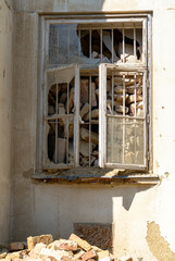 Fototapeta na wymiar Image of a damaged and collapsed window within an old building with a pile of bricks