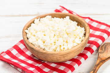 Curd or cottage cheese at wooden table.