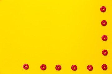On a yellow background, there are rings of red color of the same size, which form a frame on children's education and development. Backdrop for placing text and other information