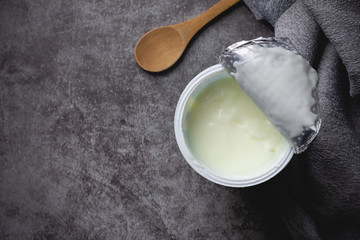 yoghurt in plastic cup on table