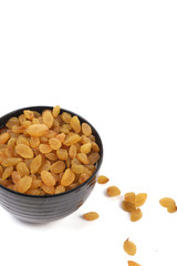 Bowl with dried golden raisins isolated on white. Dried Grapes.
