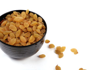 Bowl with dried golden raisins isolated on white. Dried Grapes.