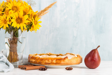 Pear delicious pie, homemade pastry with cinnamon and flowers, sweet dessert for breakfast. Copy space.