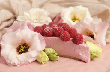 Raspberry cheesecake with berries and fresh flowers on pink plate food photo, sweet cake food photo art, kitchen, menu and restaurant photoshoot