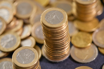 Stock Photo - Euro coins. Euro money. Euro currency.Coins stacked on each other in different positions. Money concept