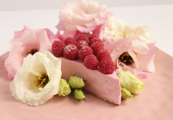 Raspberry cheesecake with berries and fresh flowers on pink plate food photo, sweet cake food photo art, kitchen, menu and restaurant photoshoot