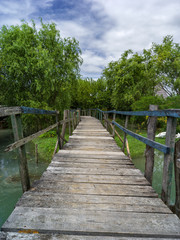 Naklejka na ściany i meble Lagoon landscape with wooden bridge and blue sky
