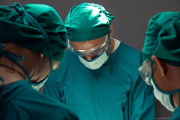 Fototapeta na wymiar concentrated professional surgical doctor team operating surgery a patient in the operating room at the hospital.