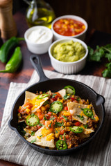 nachos in skillet pan on white background