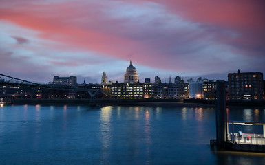Naklejka na ściany i meble A view across the River Thames at dusk towards St. Paul's Cathedral in London, UK.