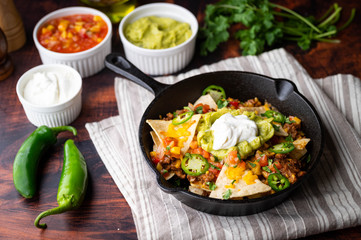 nachos in skillet pan on white background