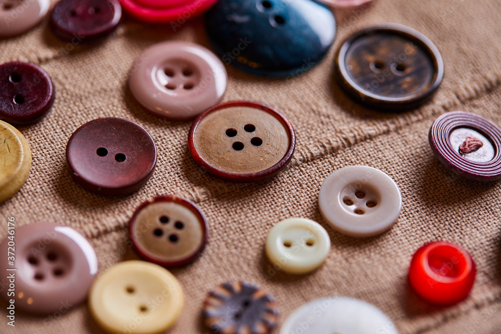 Poster background and texture of multicolored antique buttons and sewing tools