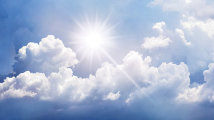 Panorama of blue sky with white curly clouds and bright sun