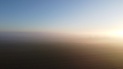 Foggy Morning Over Field and Forest