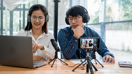 Young business people recording a podcast in a studio
