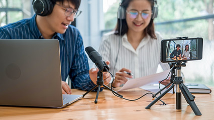 Young business people recording a podcast in a studio