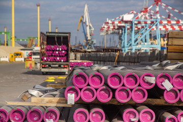 Storage of metal pipes in a pile in an open warehouse in the port.