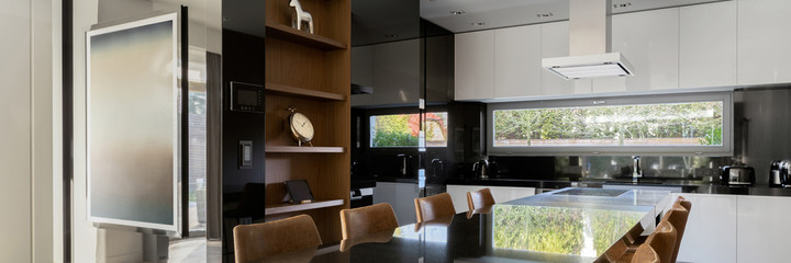 Panorama of stylish kitchen with dining table