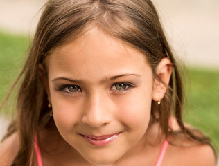 Naklejka premium Portrait of a cute happy girl with blue eyes and a beautiful smile
