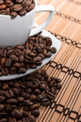 cup and saucer with coffee beans