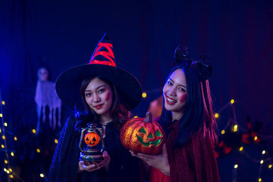 Asian women in witch costume in dark night forest scene. Halloween party concept.  party art design concept.