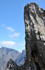 A rock pinnacle piercing the blue sky surrounding the Stettyn Mountains in the Western Cape
