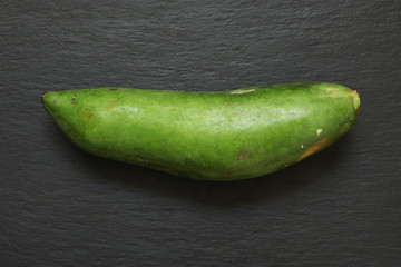 Photography of a whole papaya also know as pawpaw on slate background for food illustrations
