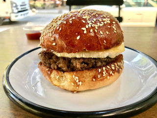 Sweet Hamburger with Brie Cheese and Honey at Fast Food Restaurant.