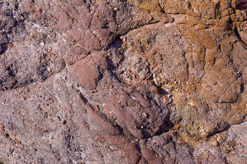 Dark red natural mineral texture stones in the beach