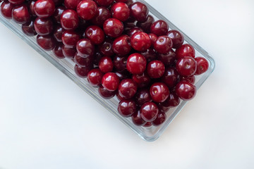 Cherry berries in glass platter isolated on white background. Delicious berries. Harvesting concept.