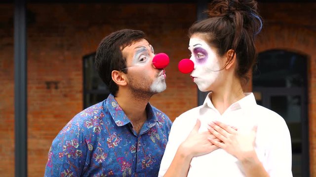 Two funny clowns kissing, pantomime, mimes, performance