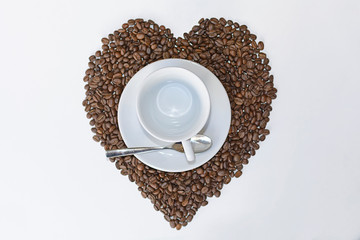 Empty coffee cup and coffee bean hart drawing on white table