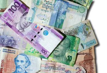 Banknotes of different countries over a white background