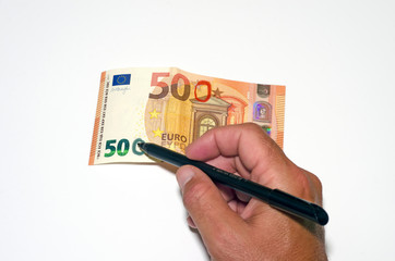 Hand adding a zero to a 50 euro bill