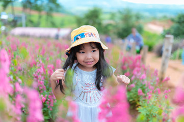 Portrait of cute asian girl in the flowers field