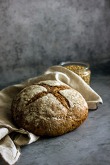 Loaf of homemade buckwheat bread on a dark background close-up copy space