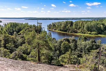 Fototapeta na wymiar Russia, Lake Ladoga, August 2020. View of the reservoir from a high granite rock.